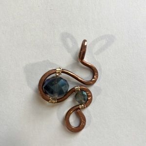 A handmade copper pendant